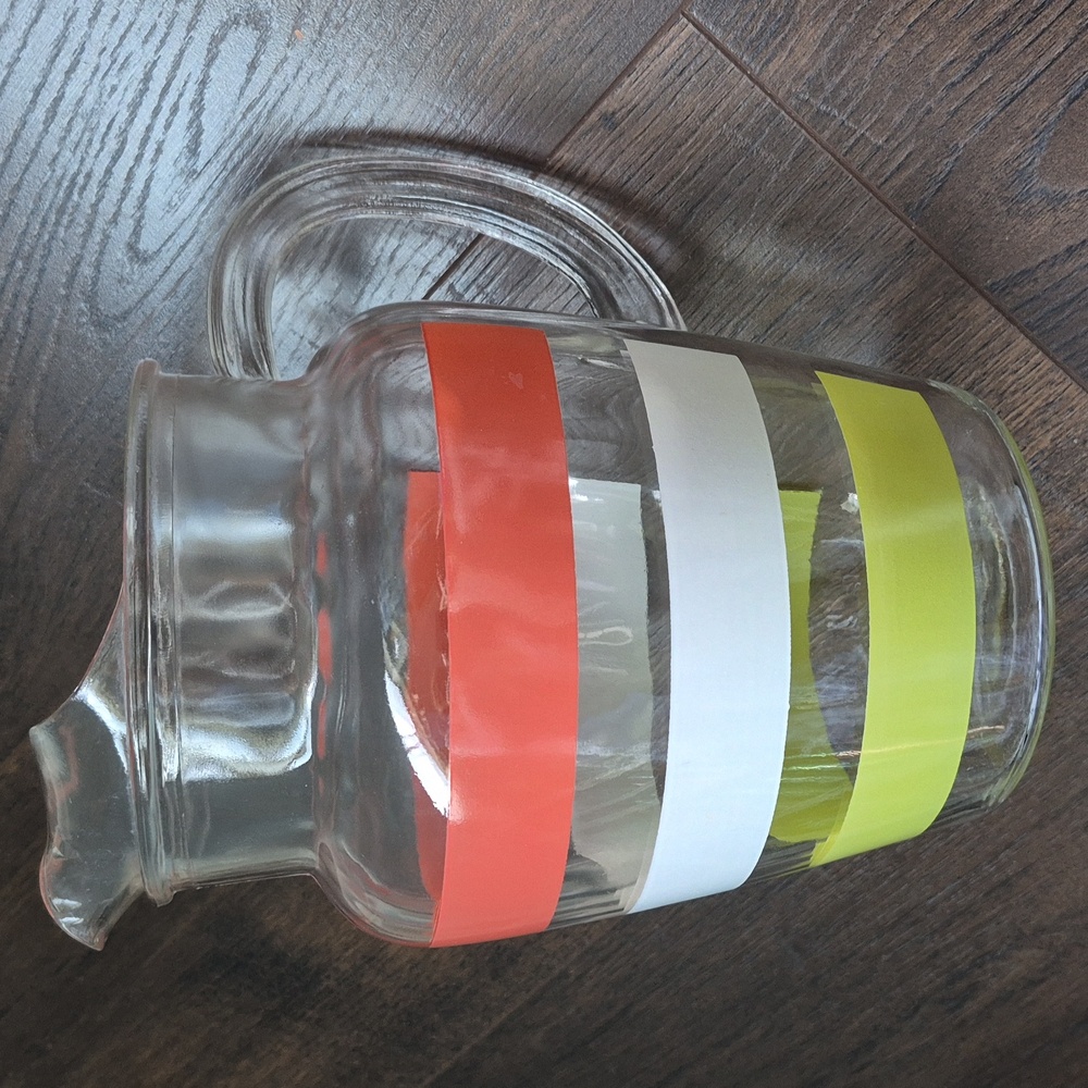 Vintage retro striped pitcher made of pressed glass.  Green Orange White